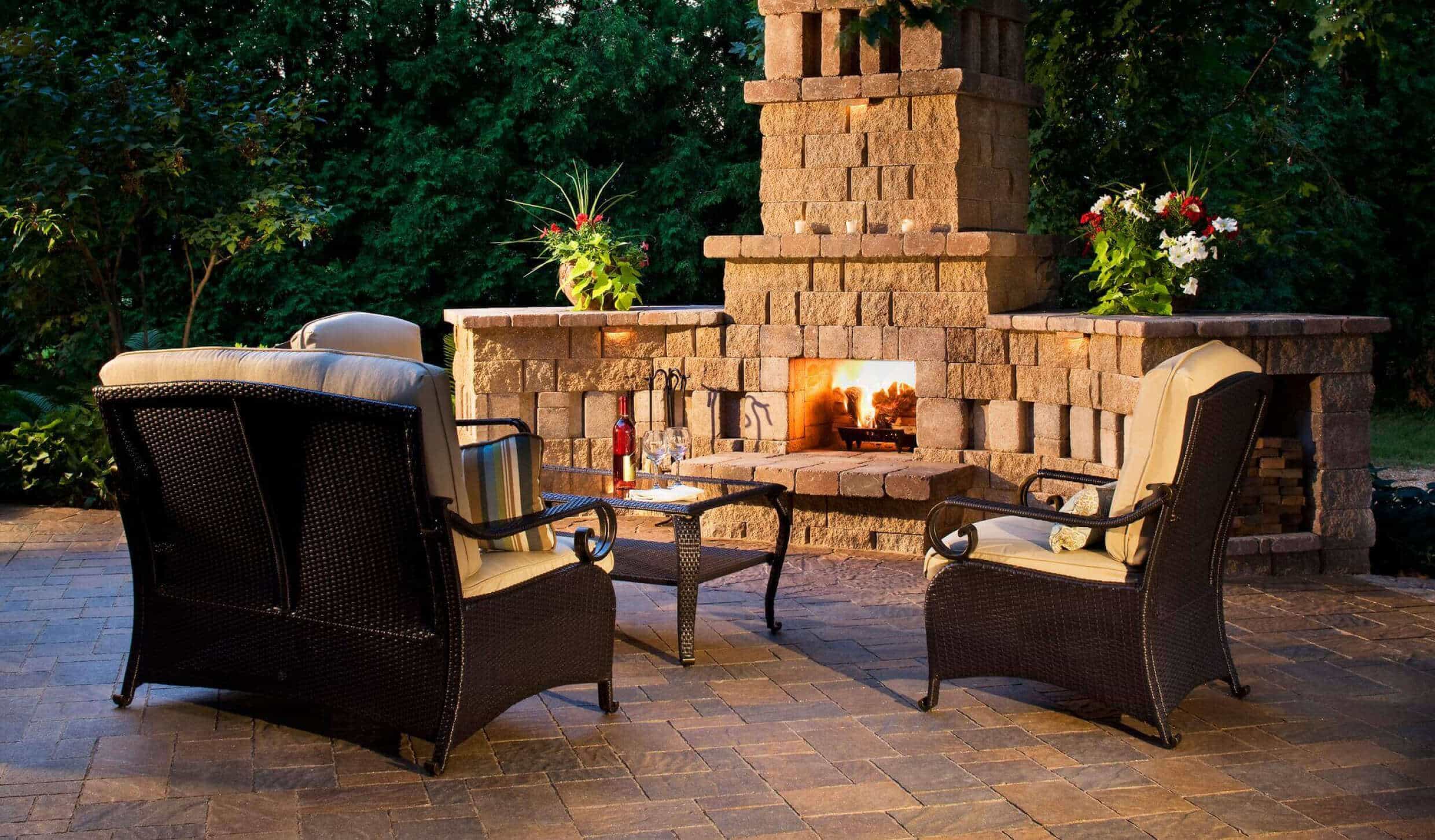 An outdoor stone fireplace that is durable and built to last