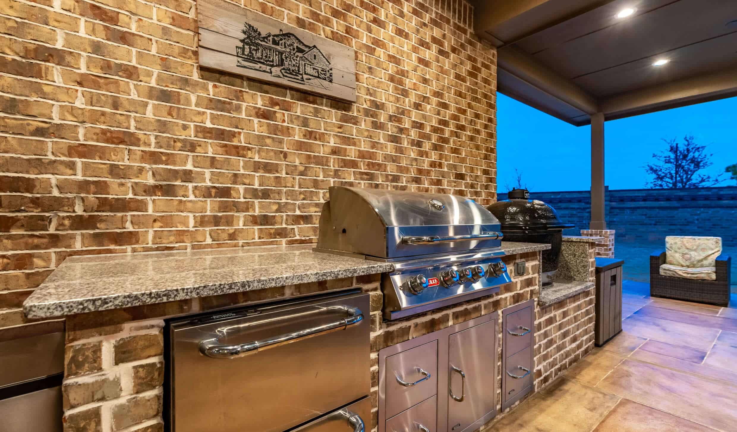 An outdoor kitchen tucked underneath a custom patio cover