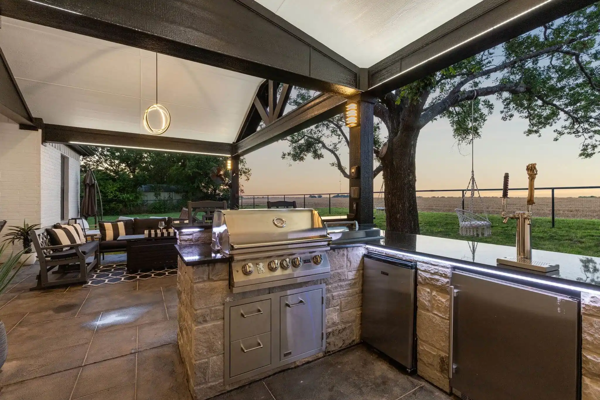 outdoor bar and covered patio dining in texas backyard, grill and kegerator taps